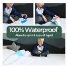 Little boy pouring blue liquid on the white bamboo mattress protector showcasing the absorbency.