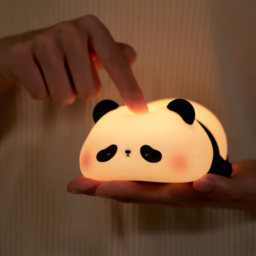A person pressing the panda nightlight