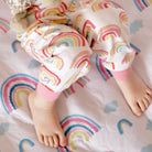 Child's feet on the rainbow mattress protector