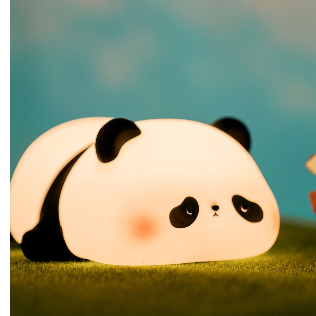 Panda designed nightlight sitting on some artificial grass