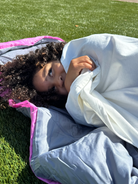 Little girl sleeping outside in a sleeping bag using her waterproof sleeping bag liner.