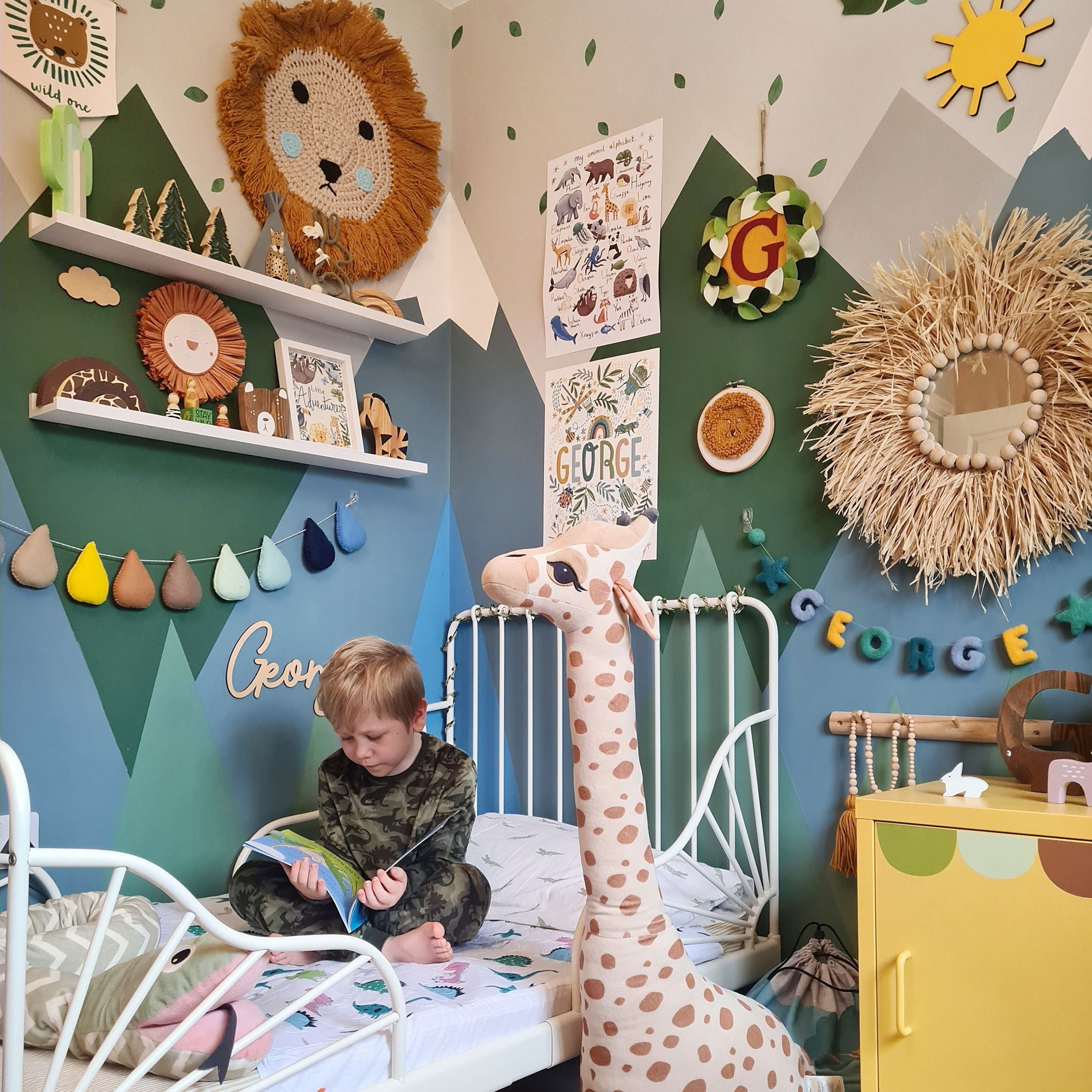 Child reading a book on their dinosaur-patterned waterproof mattress protector