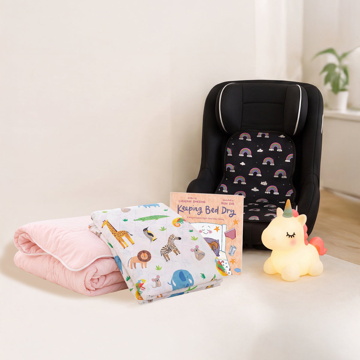 Pink coverless duvet, safari waterproof sheet, training book, unicorn nightlight and rainbow car seat protector bundle.