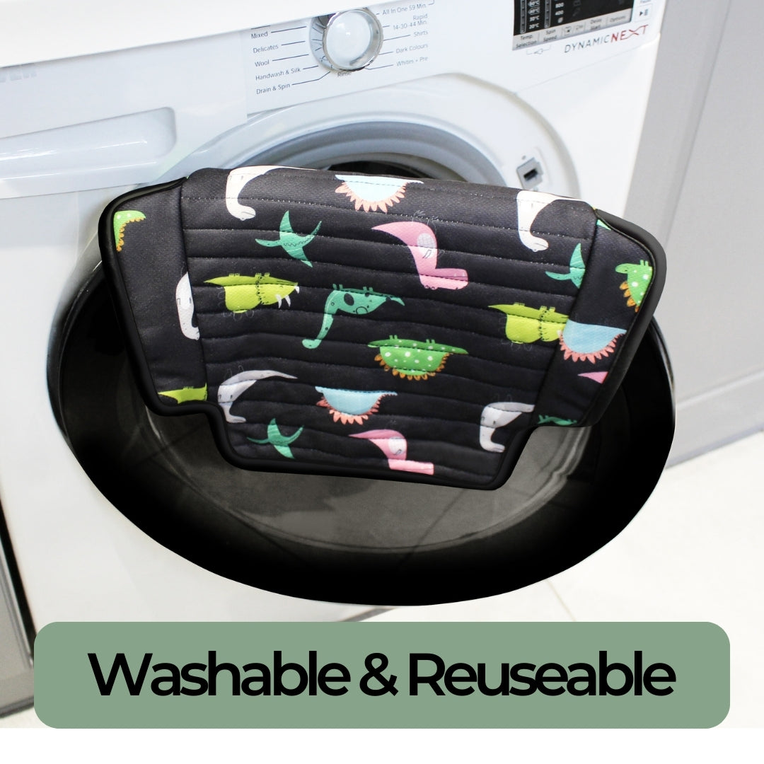 Reusable car seat protector with dinosaur pattern resting on a washing machine, labeled 'Washable & Reusable'.